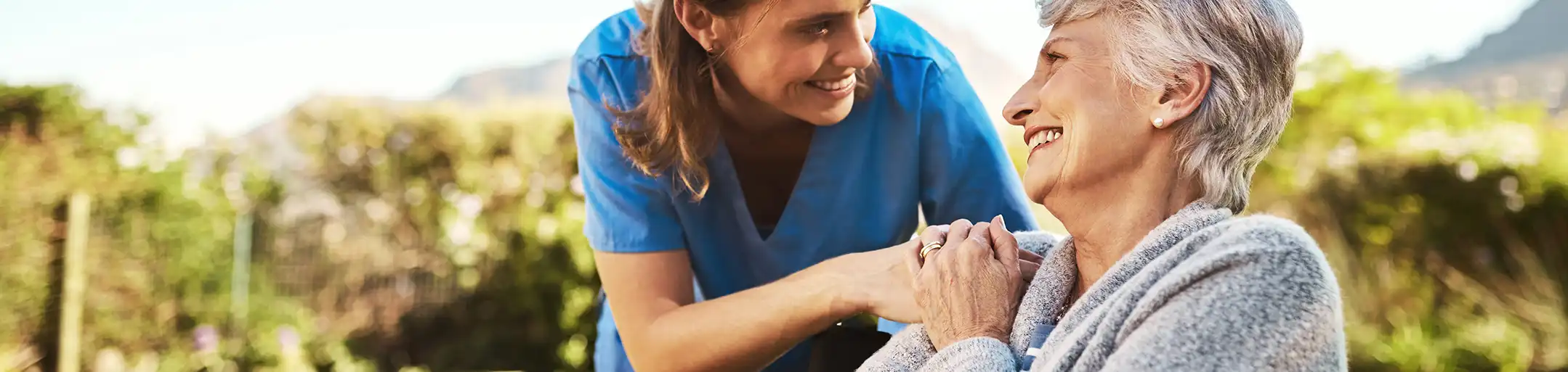 Caregiver providing compassionate memory care support to a resident in a calm assisted living home near Pocatello Idaho